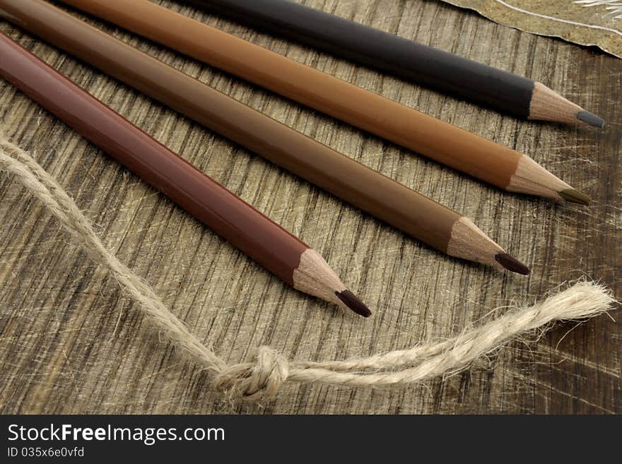 Colored pencils on the grunge desk. Colored pencils on the grunge desk