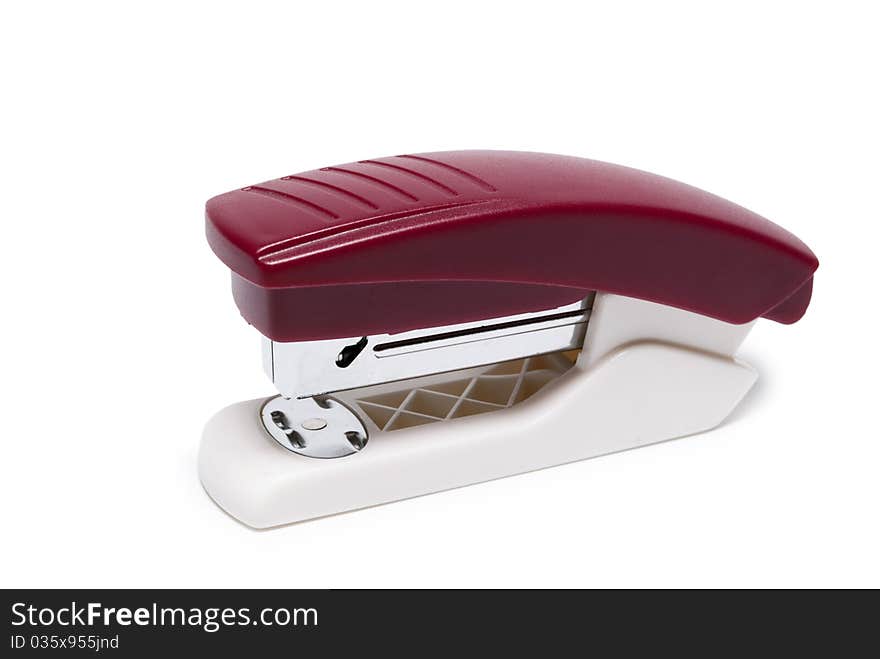 Stapler in red on a white background isolated. Stapler in red on a white background isolated