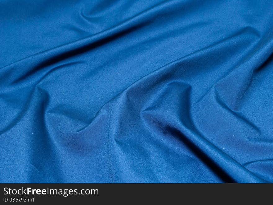 The fabric is blue, close-up. The fabric is blue, close-up