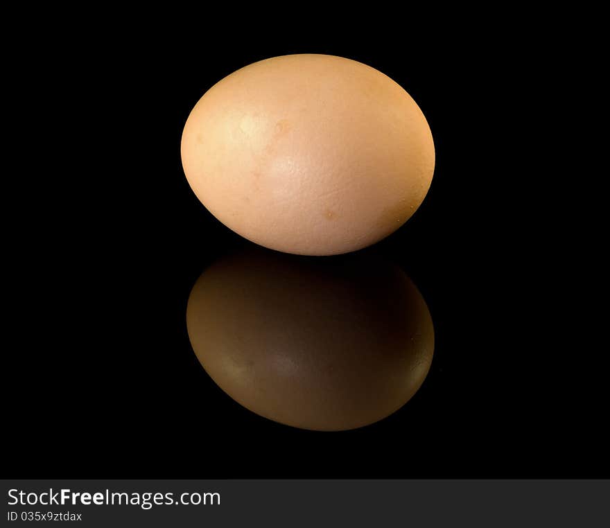 Egg on glossy black surface