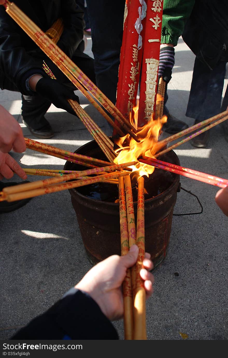 People are wishing by pay respect to the Buddha. They use incense to be the intermediate between them and Buddha. People are wishing by pay respect to the Buddha. They use incense to be the intermediate between them and Buddha.