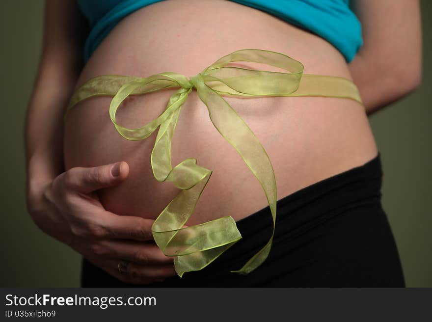 {regnant abdomen with green ribbon. {regnant abdomen with green ribbon