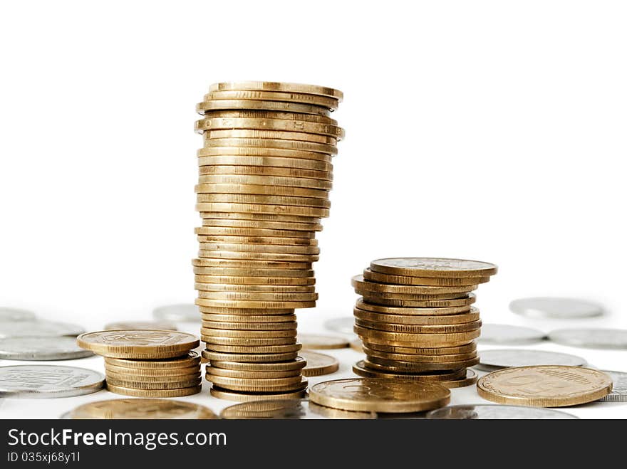 Coins from the yellow metal on a white background