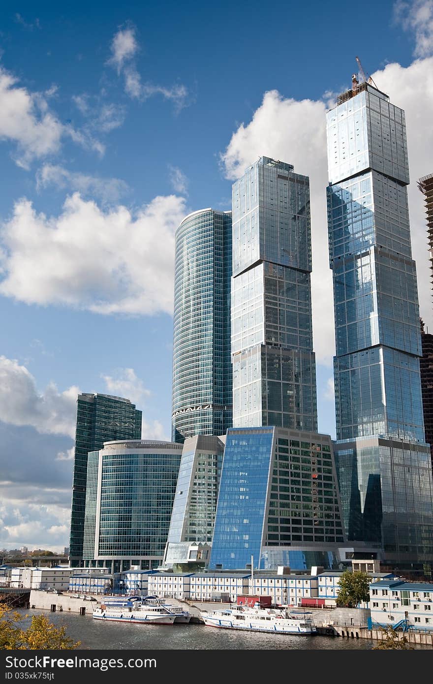 Many scyscrapers of Moscow city under blue sky with clouds