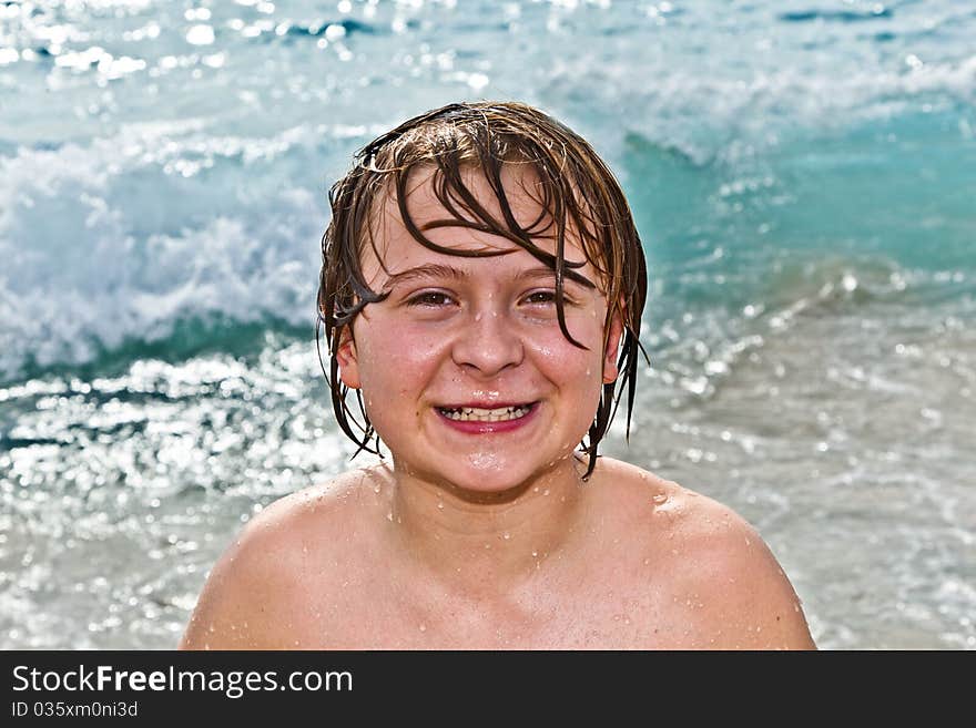 Boy has fun with the surfboard at the beach. Boy has fun with the surfboard at the beach