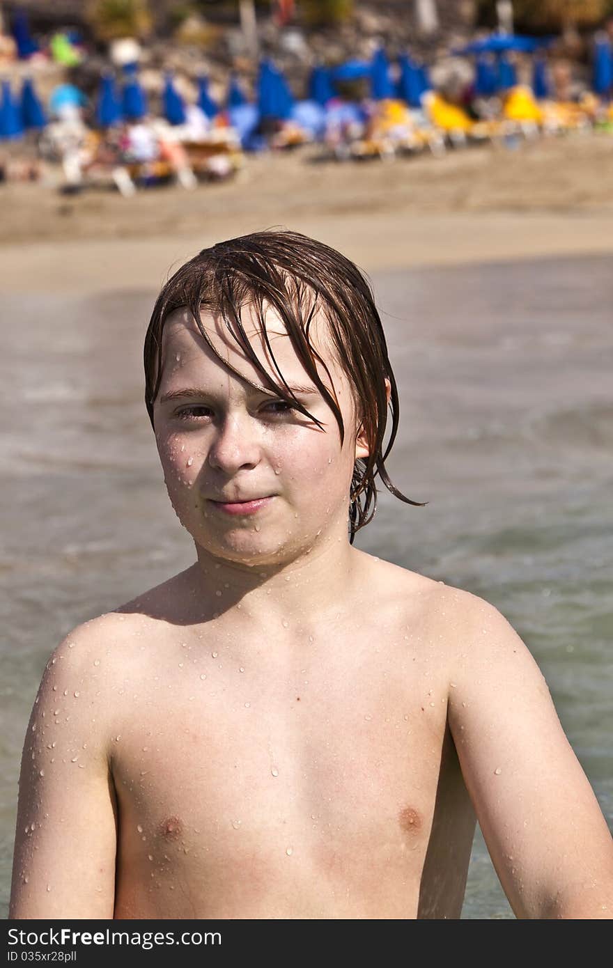 Cute boy with wet hair at the beach. Cute boy with wet hair at the beach