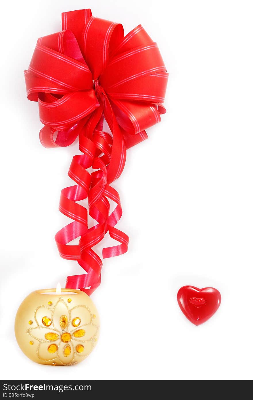 Red ribbon, a heart and a burning candle isolated on white background. Red ribbon, a heart and a burning candle isolated on white background