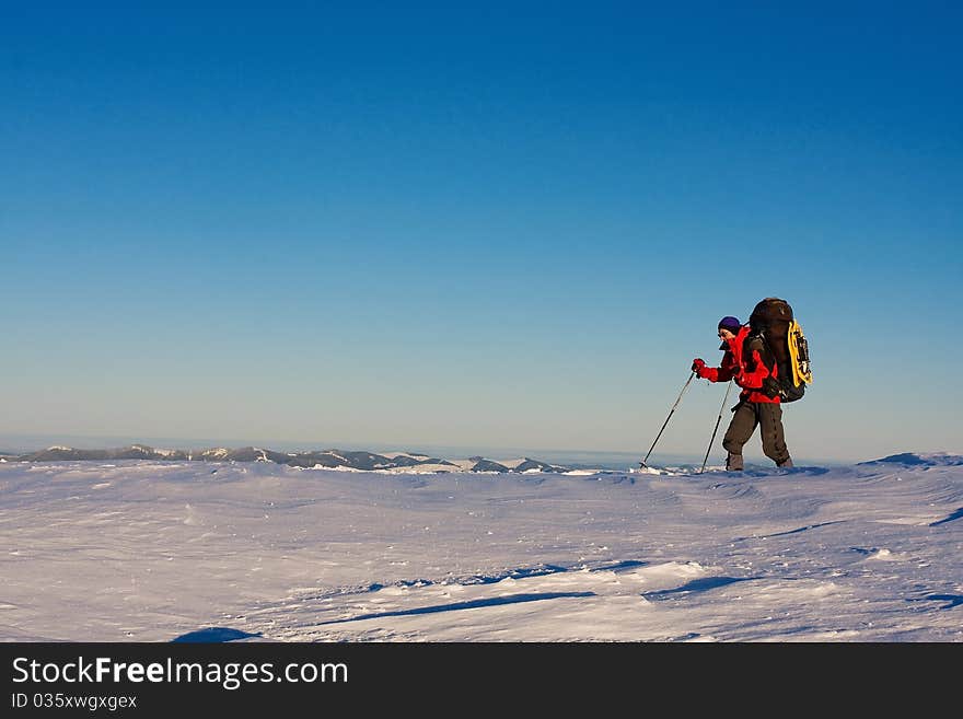 Hiker boy in winter mountains