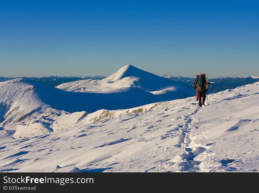 Hiker boy in winter mountains