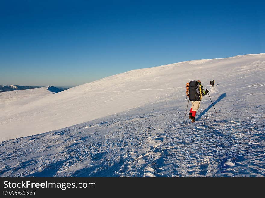 Hiker boy in winter mountains