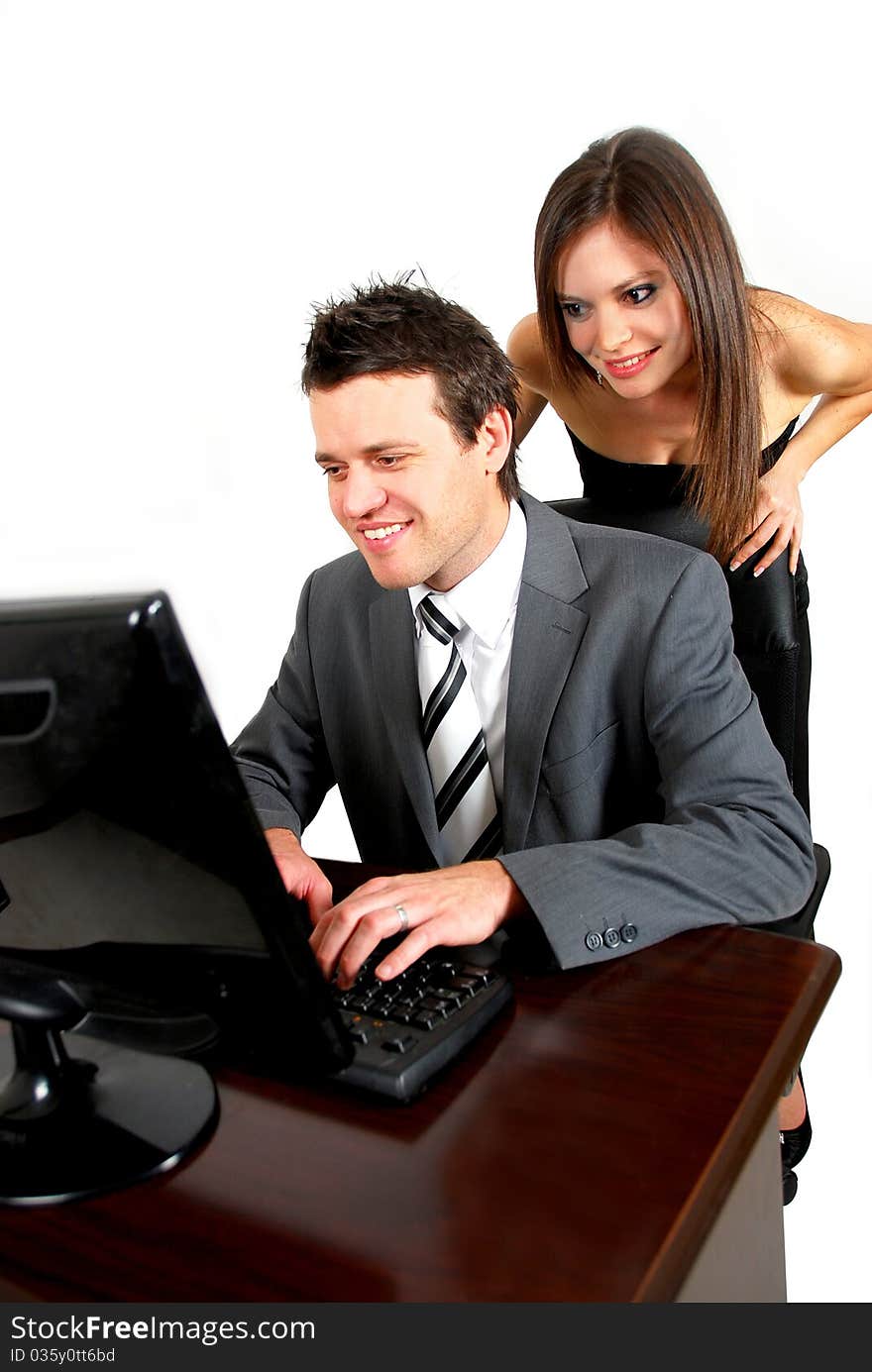 Business man working on a computer with woman watching over his shoulder. Business man working on a computer with woman watching over his shoulder