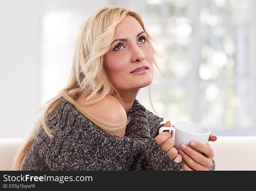 Beauty, blondie woman with an white-colored cup