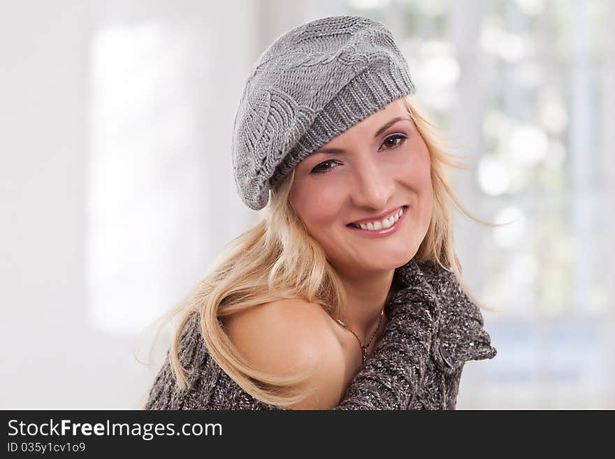 Beauty, blondie woman wear a grey-colored hat