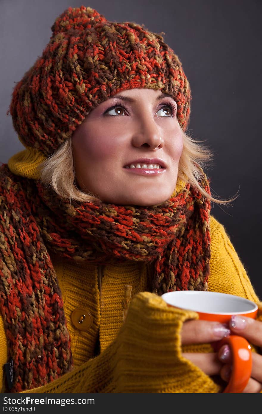 Beauty, blondie woman with an orange-colored cup. Beauty, blondie woman with an orange-colored cup