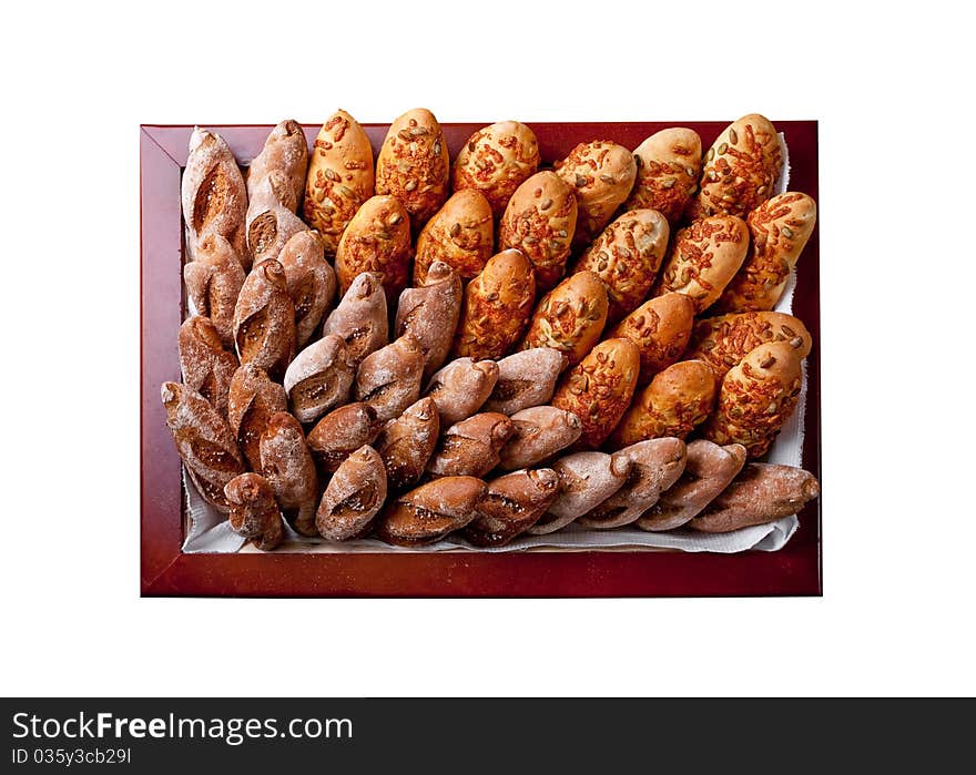 Various bakery products in a square basket (view from above) isolated on white