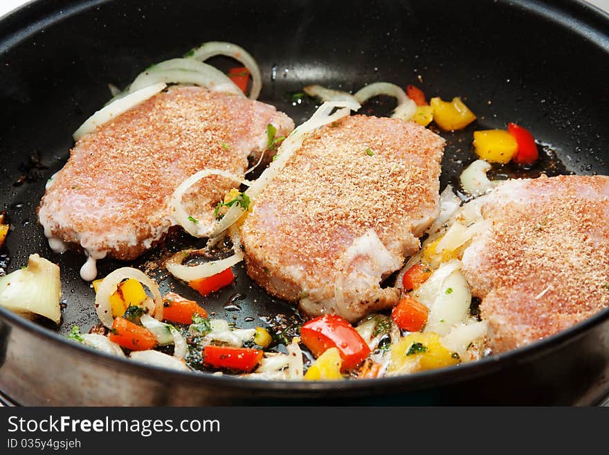 Fried pork chops in the pan