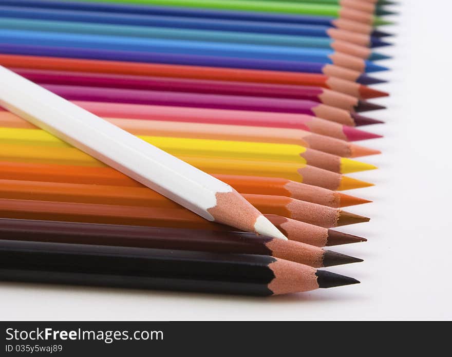 Crayons lined with white pencil over, on white background. Crayons lined with white pencil over, on white background