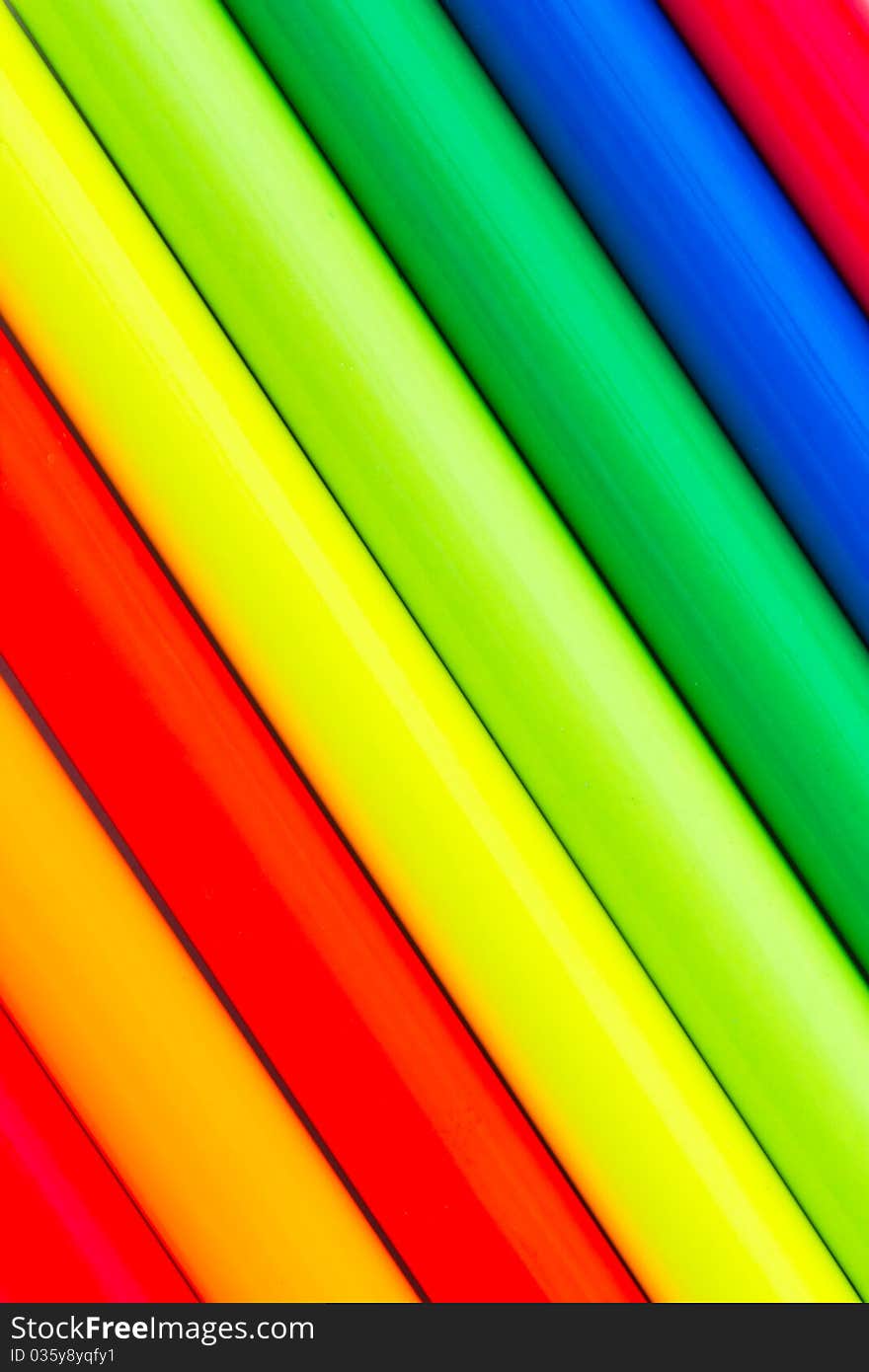 Extreme colors, ultra-bright multi colored pencils isolated on white close-up