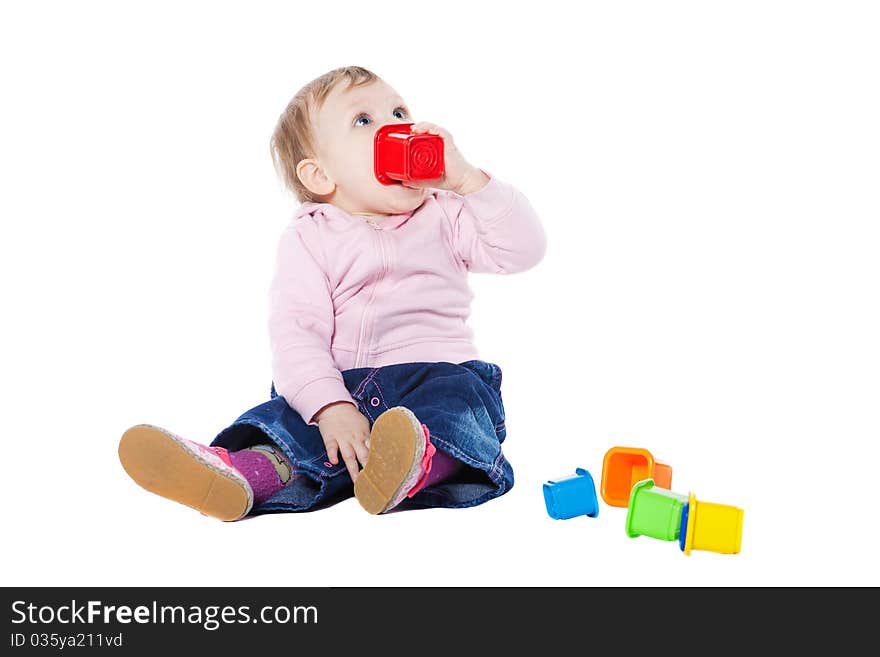 Happy baby girl sitting on floor playing with toy. Happy baby girl sitting on floor playing with toy