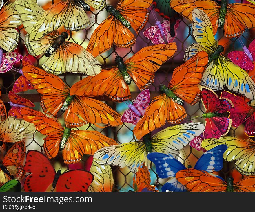 Mutliple colorful butterflies create natural-themed background. Mutliple colorful butterflies create natural-themed background