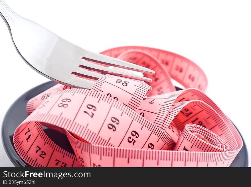 Measuring tape and fork isolated on white background