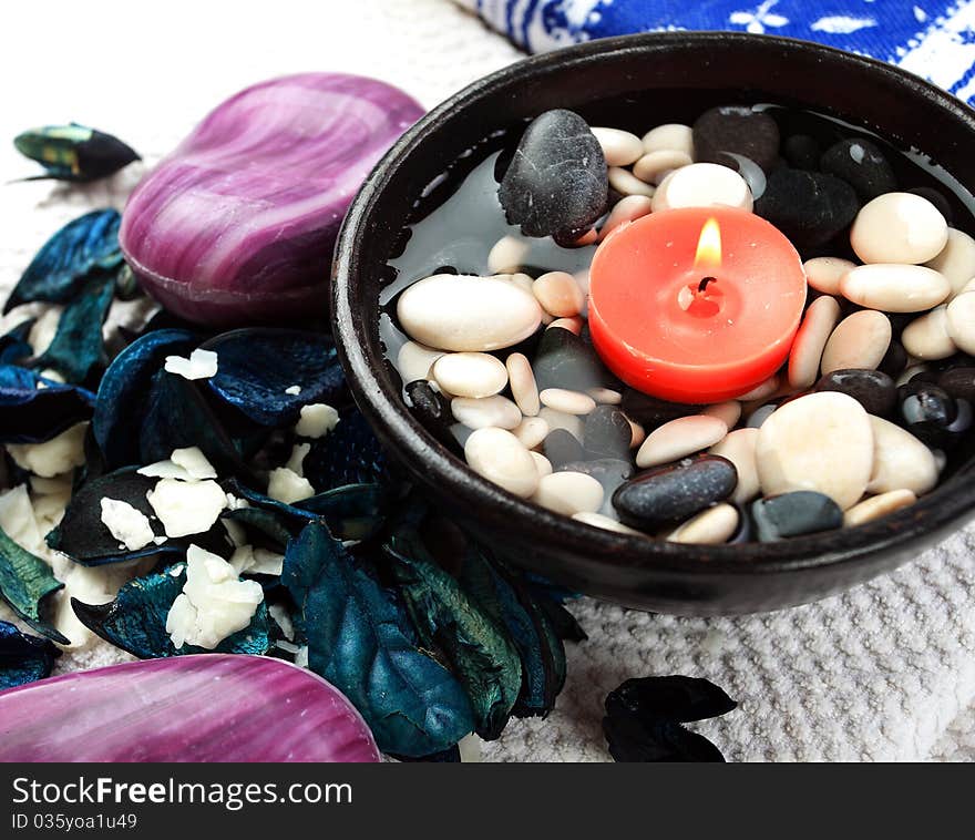 Soaps, shell, candle and blue potpourri on a white towel. Soaps, shell, candle and blue potpourri on a white towel