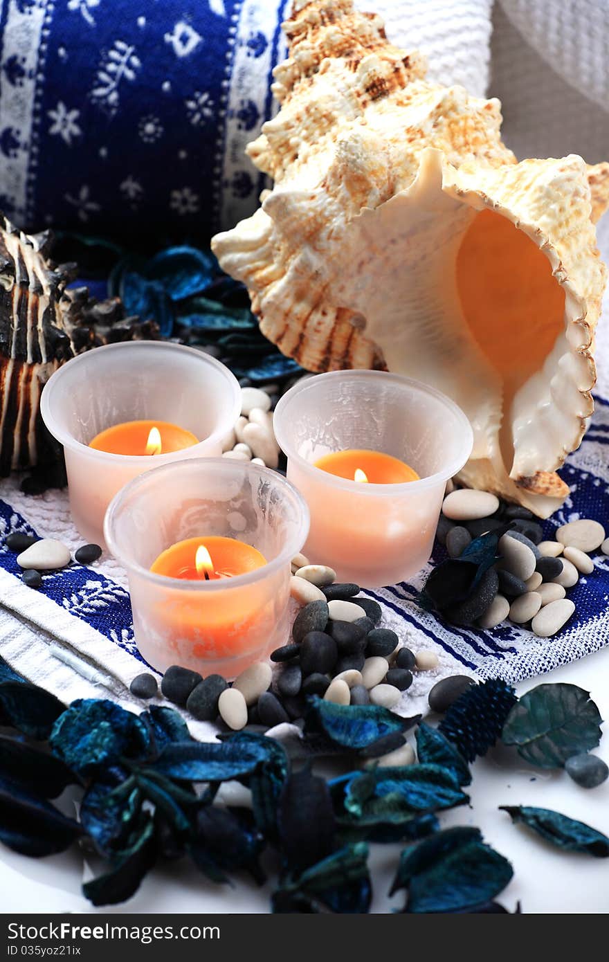 Candles and shells placed on a towel. Candles and shells placed on a towel