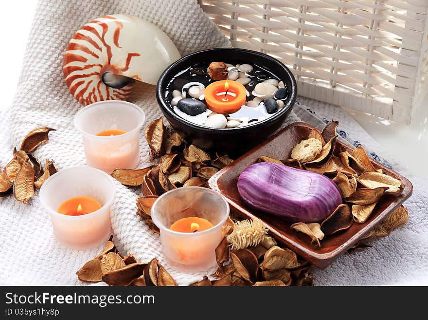 Seashell, candles and potpourri placed on a towel. Seashell, candles and potpourri placed on a towel