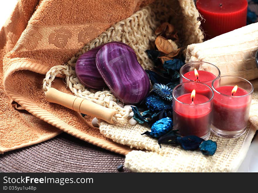 Three red candles and two soaps on a towels. Three red candles and two soaps on a towels