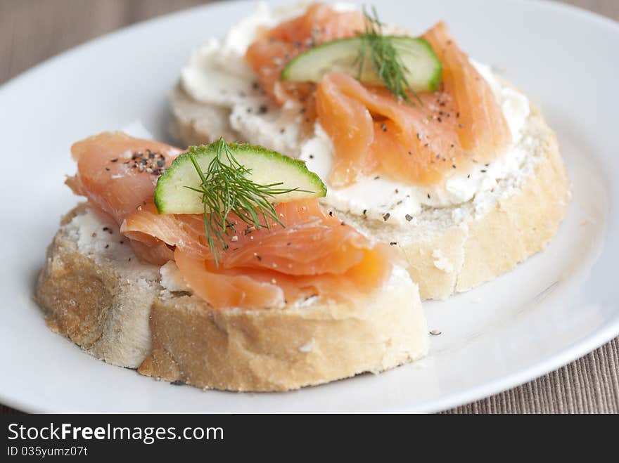 Toasted bread with cheese spread and smoked salmon. Toasted bread with cheese spread and smoked salmon