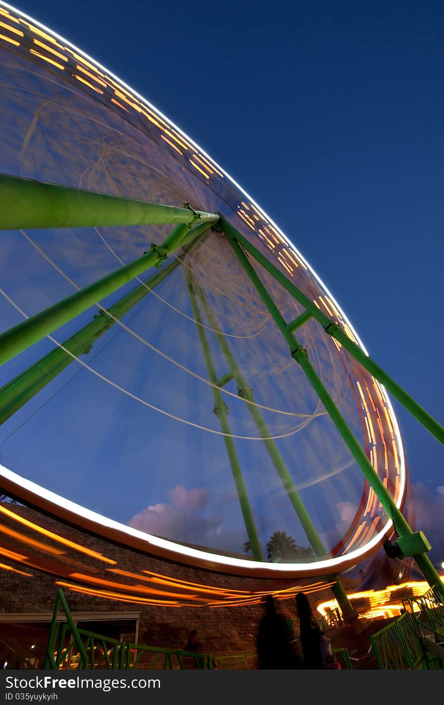 Ferris wheel turning around  in an amusement park