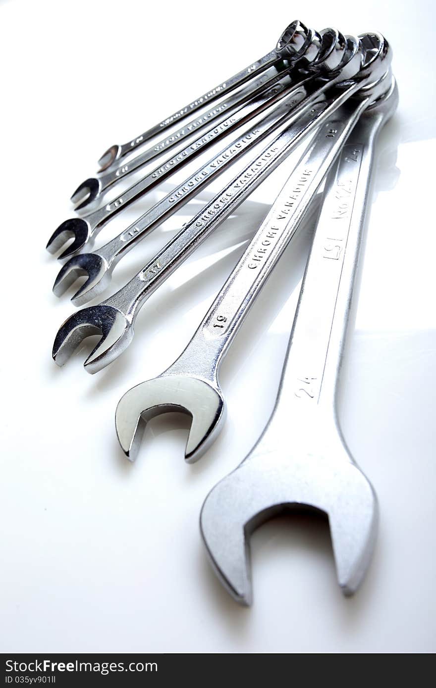 Set of steinless steel wrenches on a white background