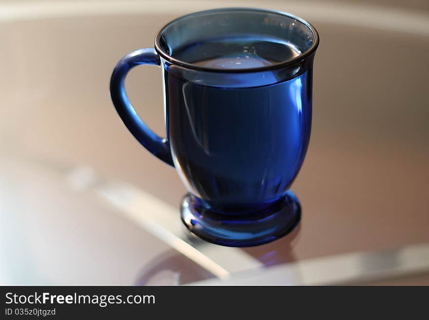 A full bright blue mug. A full bright blue mug