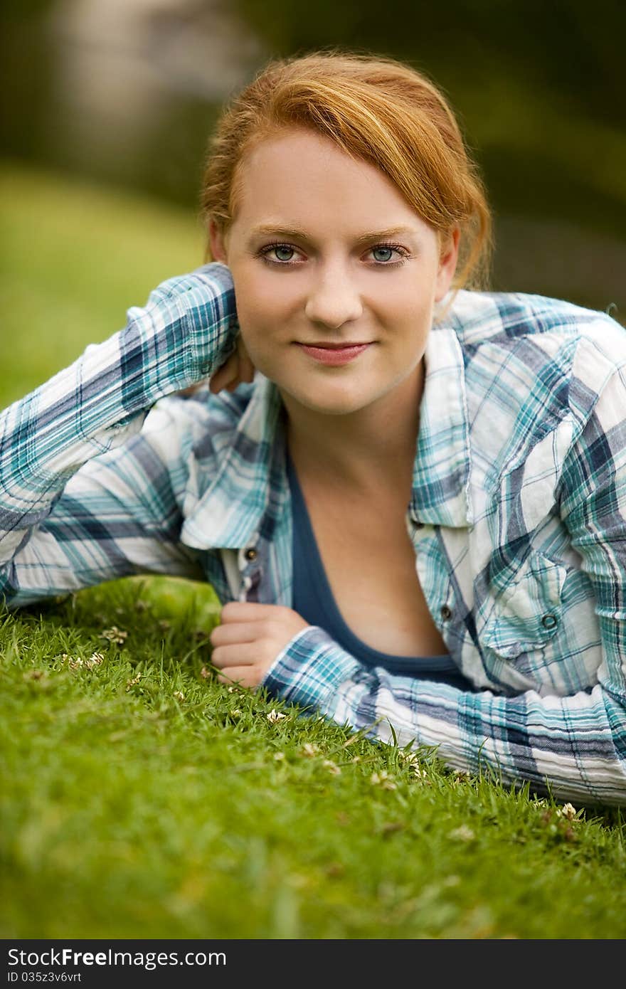 Pretty young woman sitting outside