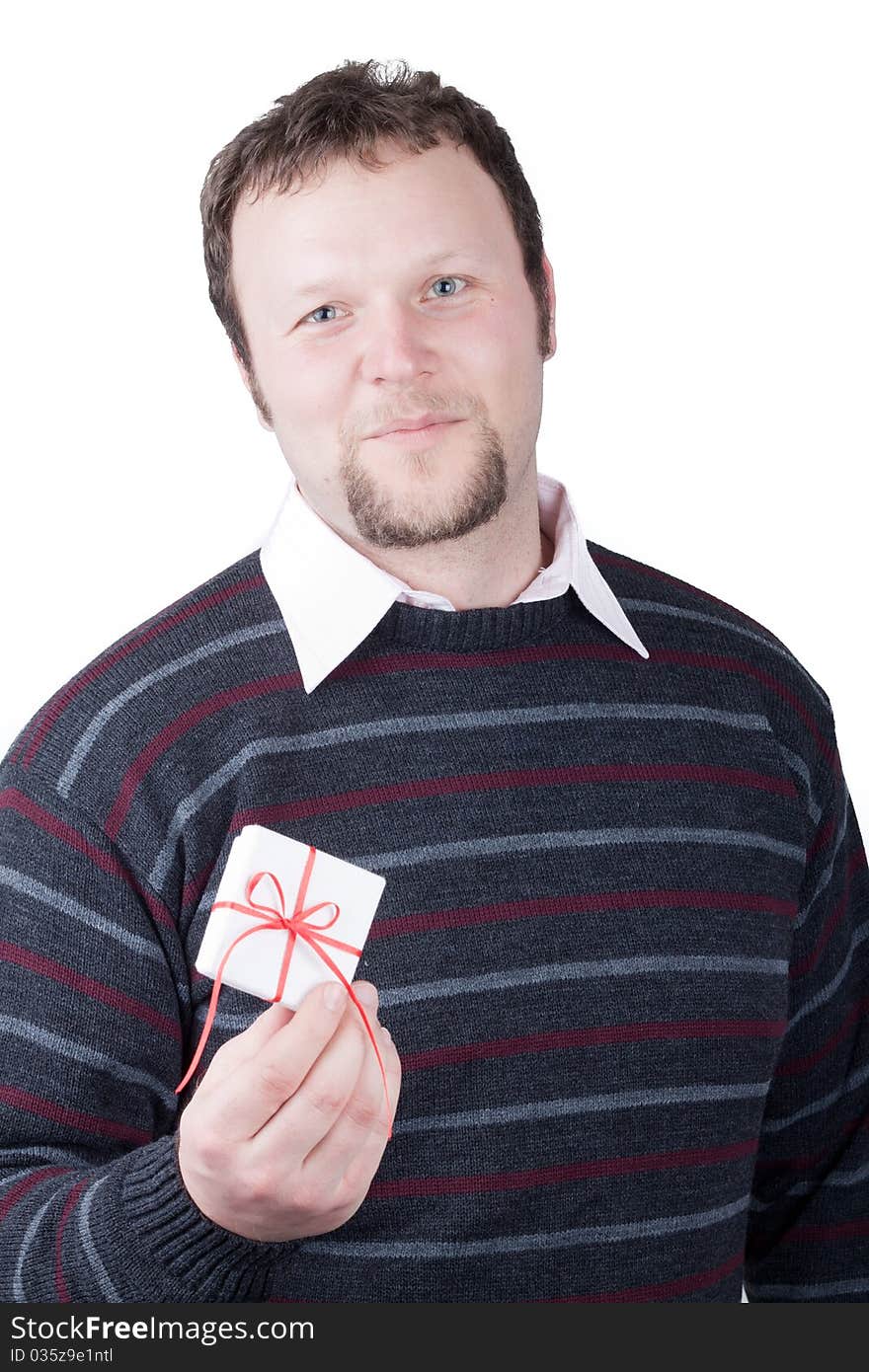 Young man holding valentine gift in his hand. He is giving it somebody. Isolated on white.