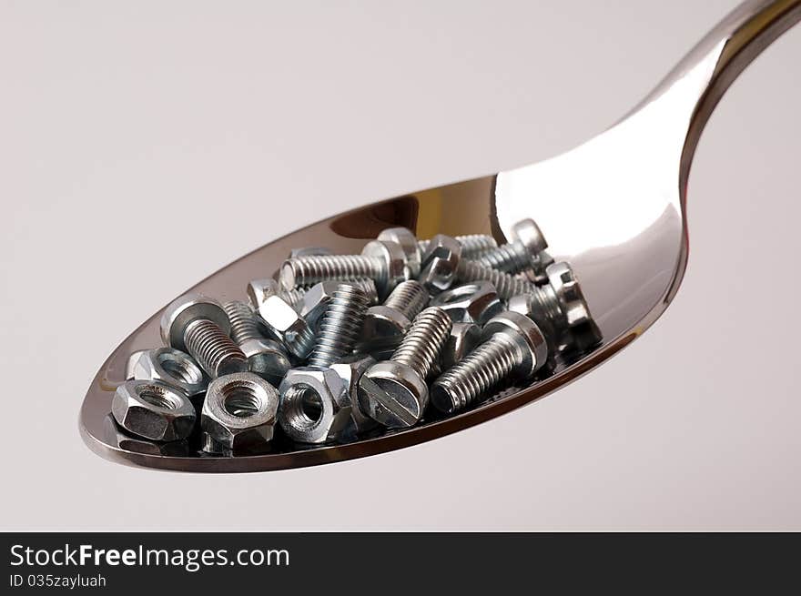 Spoon with bolts and nuts. Spoon with bolts and nuts