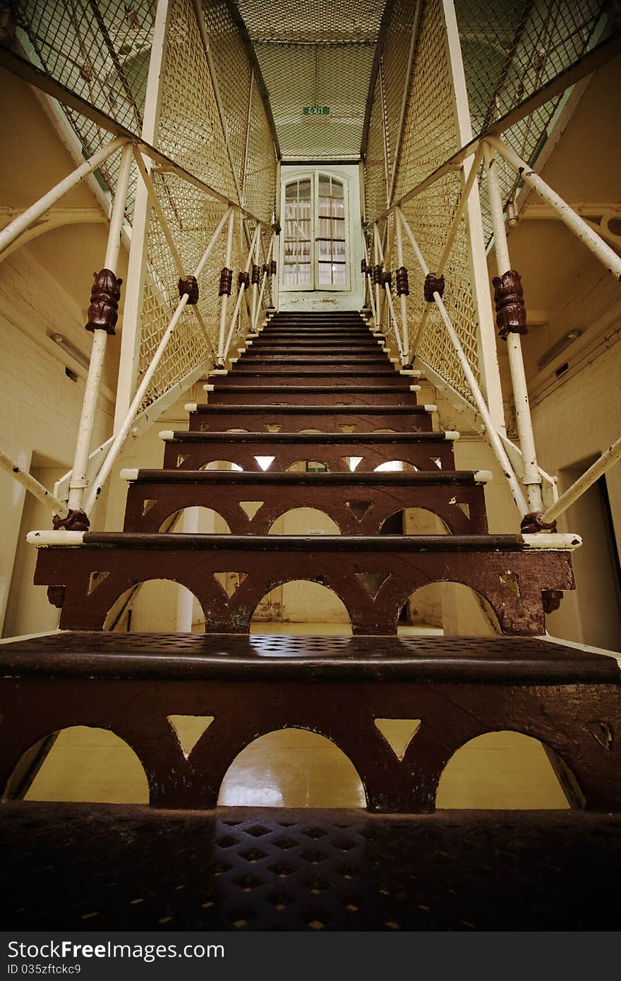 Low angle view of a steel staircase in an old prison. Low angle view of a steel staircase in an old prison.