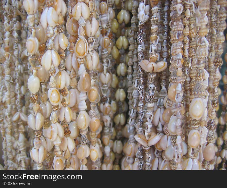 String of shell necklaces in beige and white shades.