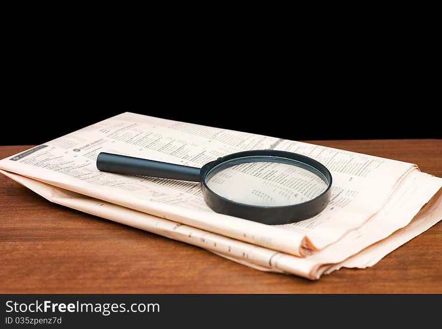 Magnify glass over a of newspaper