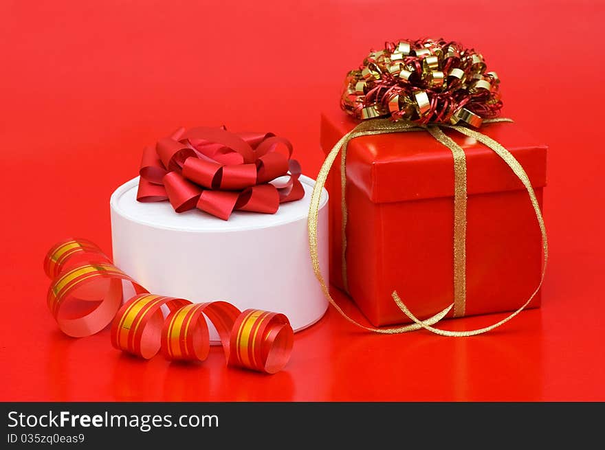 Box with a gift on a red background still life