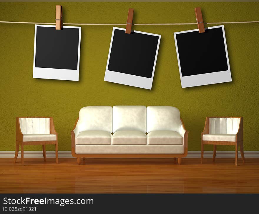 White couch and two chairs and hanging frames in green interior