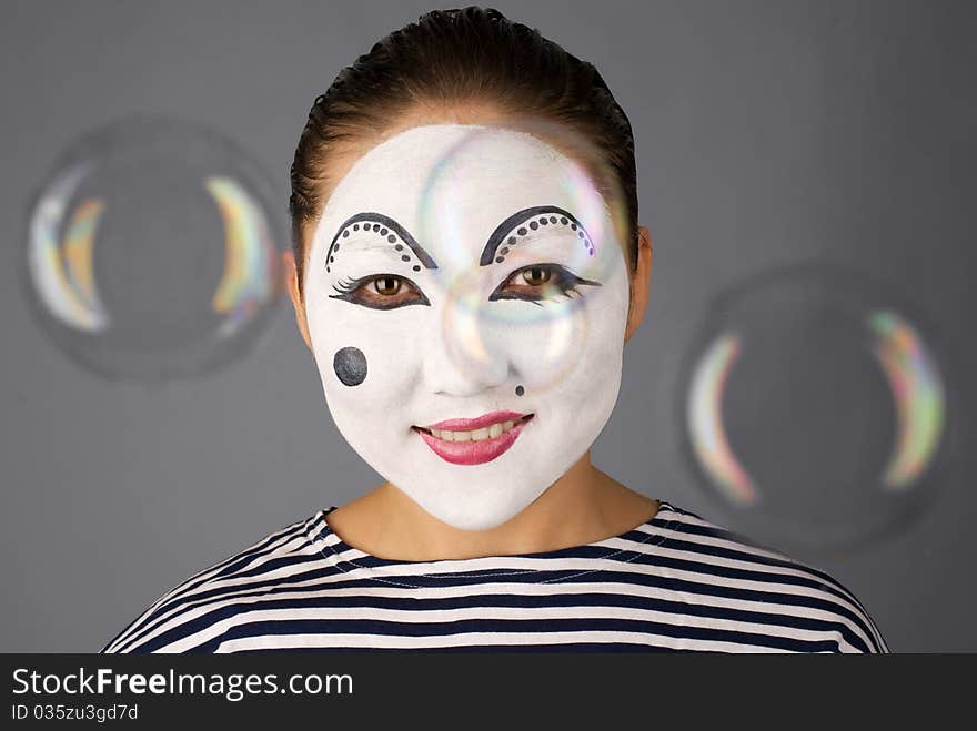 Asian mime looking to the camera trough the bubbles. Asian mime looking to the camera trough the bubbles