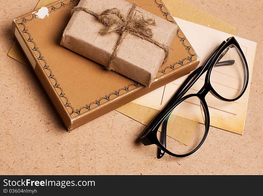 Present gift from grunge paper with glasses and postcard