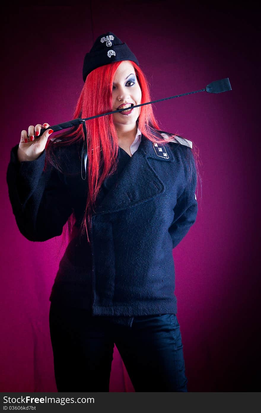 Female dressed in uniform in studio with red hair. Female dressed in uniform in studio with red hair