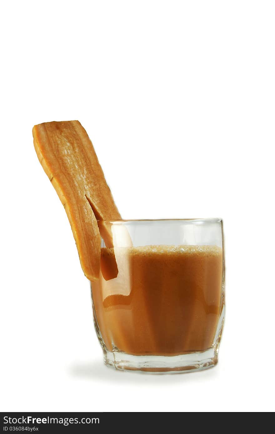 Glass of fresh carrot juice isolated on white background and glass decorated with pies of carrot