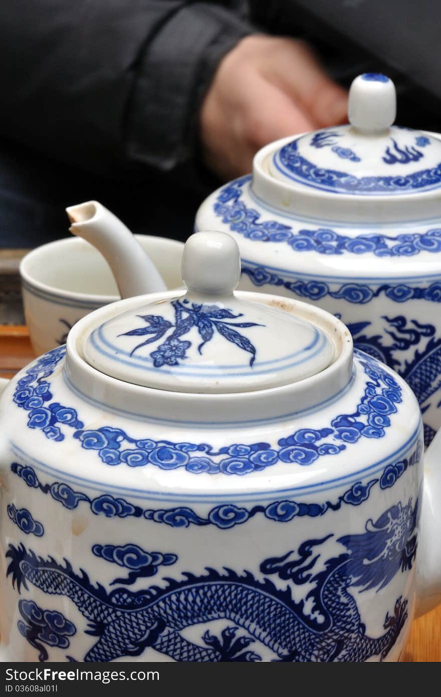 Close detail of chinese porcelain teapots with beautiful blue decoration - a dragon in the sky. Close detail of chinese porcelain teapots with beautiful blue decoration - a dragon in the sky