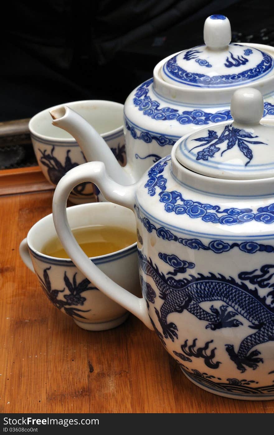 Close detail of chinese porcelain teapots with cup full of touareg tea. Close detail of chinese porcelain teapots with cup full of touareg tea