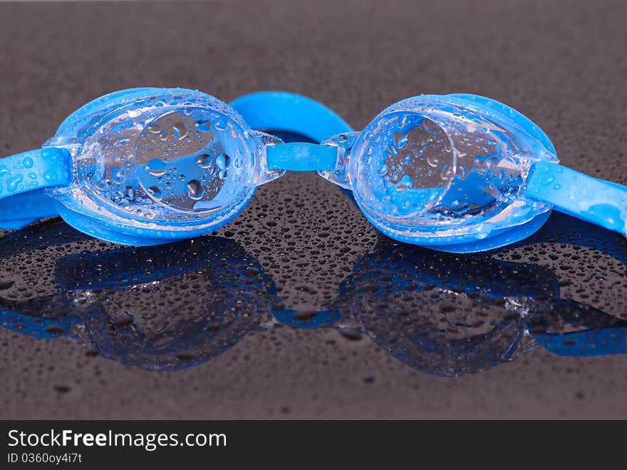 Image showing pair of wet swimming goggles and water droplets. Image showing pair of wet swimming goggles and water droplets