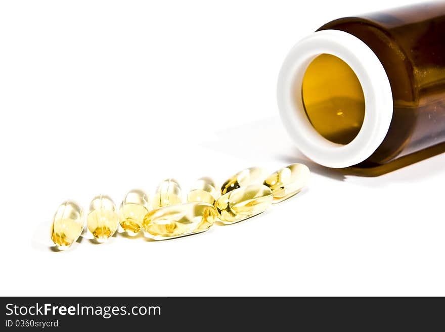 Vitamin pills with a bottle, on a white background