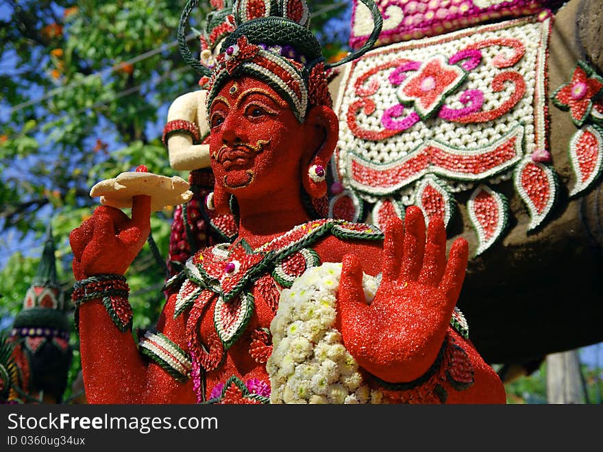 Red god decorated with flowers